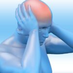 Image of a man clutching his head with headache pain