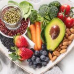 Heart-shaped dish containing various plant-based foods